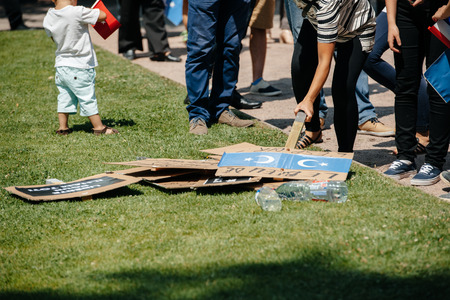 STRASBOURG, FRANCE - JULY 11, 2015: People choosing placards - Uyghur human rights activists participate in a demonstration to protest against Chinese government's policy in Uyghurのeditorial素材
