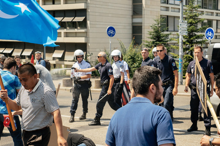 STRASBOURG, FRANCE - JULY 11, 2015: Police use pepper spray to prevent clash - Uyghur human rights activists participate in a demonstration to protest against Chinese government's policy in Uyghurのeditorial素材