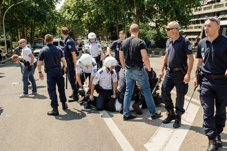 STRASBOURG, FRANCE - JULY 11, 2015: Police arresting man - Uyghur human rights activists participate in a demonstration to protest against Chinese government's policy in Uyghurのeditorial素材