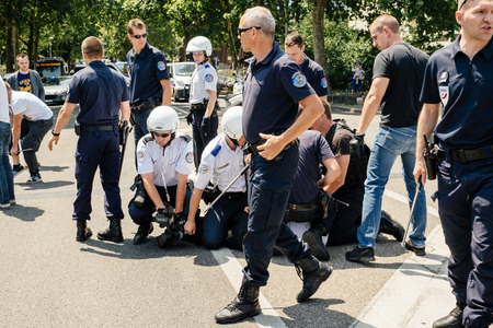 STRASBOURG, FRANCE - JULY 11, 2015: Police arresting man - Uyghur human rights activists participate in a demonstration to protest against Chinese government's policy in Uyghurのeditorial素材