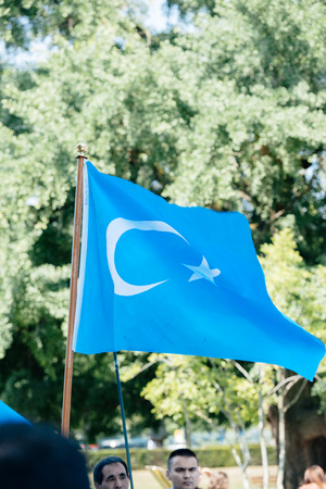 STRASBOURG, FRANCE - JULY 11, 2015: East Turkestan waving - Uyghur human rights activists participate in a demonstration to protest against Chinese government's policy in Uyghurのeditorial素材