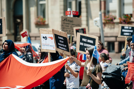 STRASBOURG, FRANCE - JULY 11, 2015: Uyghur human rights activists participate in a demonstration to protest against Chinese government's policy in Uyghurのeditorial素材