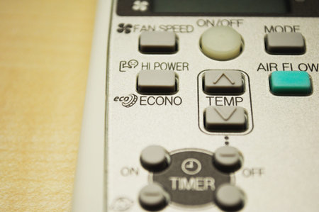 Modern air conditioning remote control on wooden tableの写真素材