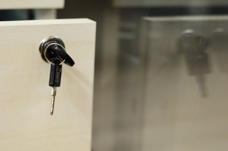 Opened locking drawer with keys, close-up - reflected in office windowの写真素材