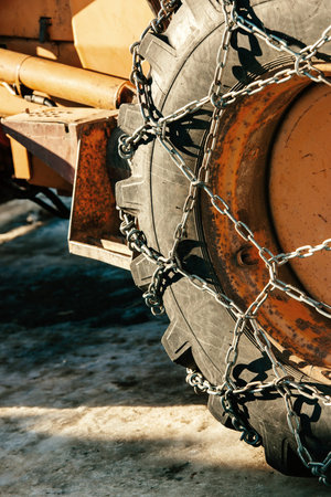 Snow chains outside of a tractor tire - winter transportation imagewinterの写真素材