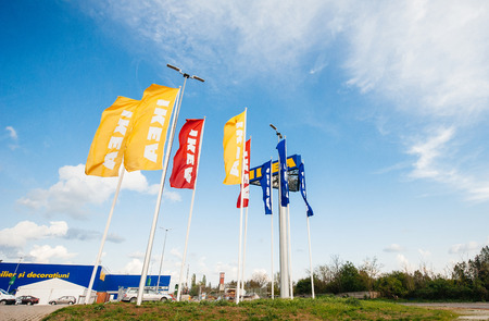BUCHAREST, ROMANIA - APRIL 30, 2011: IKEA Store flags near its entrance. IKEA is the world's largest furniture retailer and sells ready to assemble furniture founded in Sweden in 1943. It is also the largest Romanian furniture storeのeditorial素材