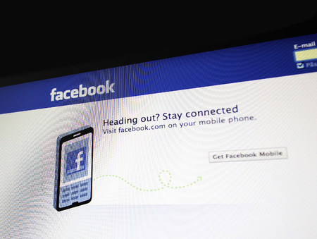 Paris, France - May 15, 2011: Apple Imac screen showing advice to get facebook for mobile. Facebook is the most used social networking service with more than 800 million active users worldwide.のeditorial素材