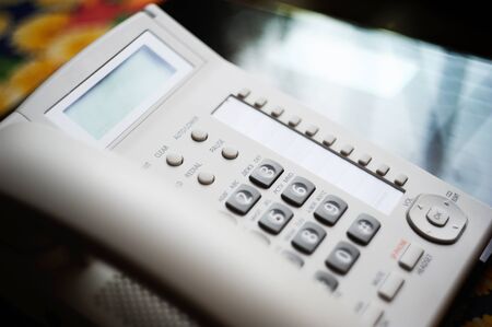 Modern executive VoIP desk phone with traditional corded headset. Shallow depth of field - focus on the center of the image.の写真素材