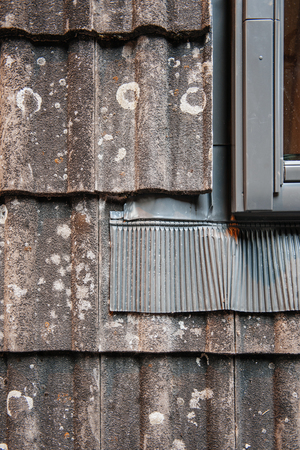Water thermal insulation of a roof tile demonstration next ot a roof windowの写真素材