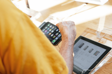 PARIS, FRANCE - SEPTEMBER 20, 2014: Man comparing the new Apple iPhone 6 and iPhone 6 Plus during the sales launch of the latest Apple Inc. smartphones at the Apple store in Paris, Franceのeditorial素材