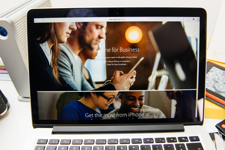 PARIS, FRANCE - SEP 10, 2015: Apple Computers website on MacBook Pro Retina in a creative room environment showcasing the newly announced iPhone 6 for Businessのeditorial素材