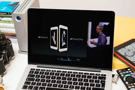 PARIS, FRANCE - SEP 10, 2015: Apple Computers website on MacBook Pro Retina in a creative room environment showcasing Tim Cook comparing iPhoneのeditorial素材