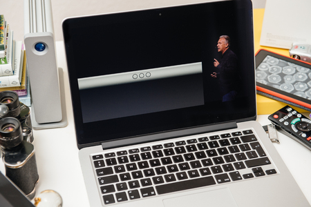 PARIS, FRANCE - SEP 10, 2015: Apple Computers website on MacBook Pro Retina in a creative room environment showcasing Philip Schiller from Apple talking about Smart Keyboard of iPad Proのeditorial素材