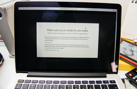 PARIS, FRANCE - SEP 10, 2015: Apple Computers website on MacBook Pro Retina in a creative room environment showcasing the newly announced iPhone 6S pre-order scheduleのeditorial素材