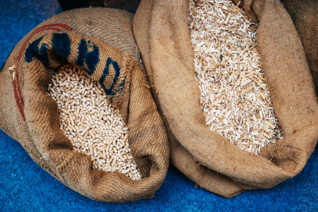 Pellets compressed organic matter, or biomass made from sawdust in their organic bags next to...