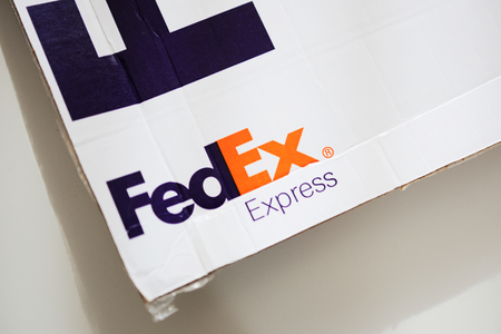 LONDON, UNITED KINGDOM - OCTOBER 18, 2014: FedEx packaging on white background. FedEx Corporation is an American global courier delivery services company headquartered in Memphis, Tennesseのeditorial素材