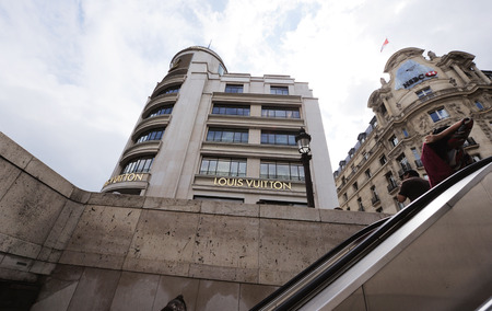 PARIS, FRANCE - JULY 13, 2011: Louis Vuitton gold letters on building facade on Champs Elysees avenue in Paris, France next to HSBC France main officeのeditorial素材