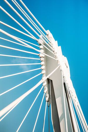 Steel details of a modern bridge against blue skyの写真素材