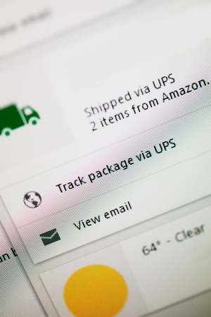 LONDON, UNITED KINGDOM - OCT 20, 2014: Shipped via UPS 2 items from Amazon text on computer screen with the optiion to track the parcels and view email.のeditorial素材