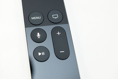 PARIS, FRANCE - NOV 10, 2015: Extreme colseup of the New Apple TV media streaming  player microconsole by Apple Computers futuristic touch remote swipe-to-select with integrated Siri and motion sensor - perspective viewのeditorial素材