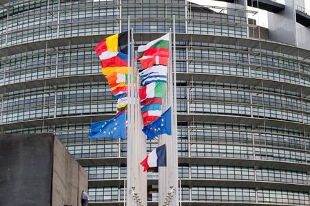 STRASBOURG, FRANCE - 14 Nov 2015: European Union Flags and France flag flies at half-mast in front of the European Parliament building following an terrorist attack in Parisのeditorial素材