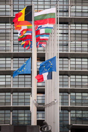 STRASBOURG, FRANCE - 14 Nov 2015: European Union Flags and France flag flies at half-mast in front...