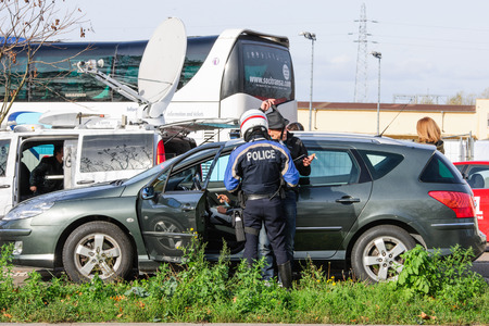 STRASBOURG, FRANCE - NOV 14 2015: French Police checking vehicles on the 'Bridge of Europe' between Strasbourg and Kehl Germany, as a security measure in the wake of attacks in Paris - officer body searching drivers, surveillanceのeditorial素材