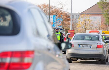 STRASBOURG, FRANCE - NOV 14 2015: French Police checking vehicles on the 'Bridge of Europe' between Strasbourg and Kehl Germany, as a security measure in the wake of attacks in Paris - two officers inspecting carsのeditorial素材