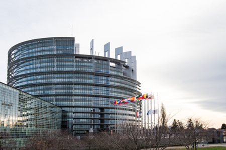 STRASBOURG, FRANCE - 14 Nov 2015: European Union Flags and France flag flies at half-mast in front of the European Parliament building following an terrorist attack in Parisのeditorial素材