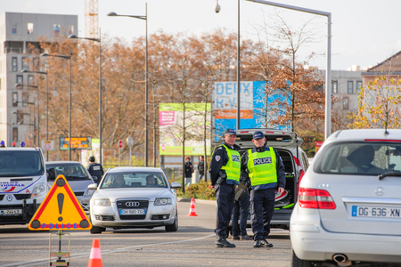 STRASBOURG, FRANCE - NOV 14 2015: French Police checking vehicles on the 'Bridge of Europe' between Strasbourg and Kehl Germany, as a security measure in the wake of attacks in Paris - two officers inspecting carsのeditorial素材