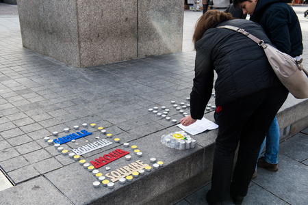 STRASBOURG, FRANCE - 14 NOV 2015: Light candles near General Kleber statue in tribute to the victims of the terrorist attacks in Paris - people writing PEACE word with candlesのeditorial素材