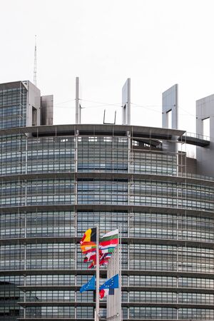 STRASBOURG, FRANCE - 14 Nov 2015: European Union Flags and France flag flies at half-mast in front of the European Parliament building following an terrorist attack in Parisのeditorial素材