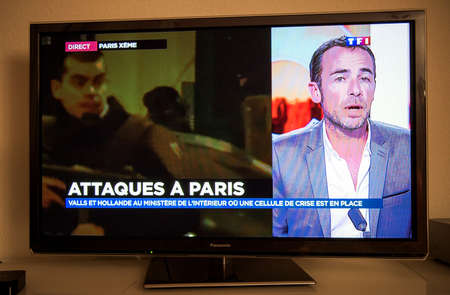PARIS, FRANCE - NOV 13, 2013: French Television reporting live as rescuers working on the schene of the attack. At least 40 people were killed across Paris, with explosions outside the national stadium where France was hosting German teamのeditorial素材