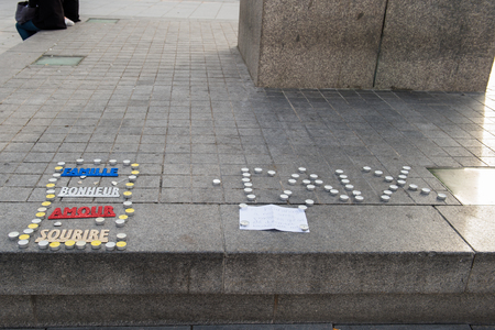 STRASBOURG, FRANCE - 14 NOV 2015: Light candles near General Kleber statue in tribute to the victims of the terrorist attacks in Paris - people writing PEACE word with candlesのeditorial素材