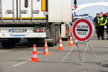 STRASBOURG, FRANCE - NOV 14 2015: French Police checking vehicles on the 'Bridge of Europe' between Strasbourg and Kehl Germany, as a security measure in the wake of attacks in Paris - slow down signのeditorial素材