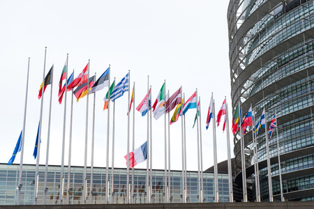STRASBOURG, FRANCE - 14 Nov 2015: European Union Flags and France flag flies at half-mast in front of the European Parliament building following an terrorist attack in Parisのeditorial素材