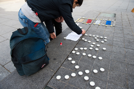 STRASBOURG, FRANCE - 14 NOV 2015: Light candles near General Kleber statue in tribute to the victims of the terrorist attacks in Paris - people writing PEACE word with candlesのeditorial素材