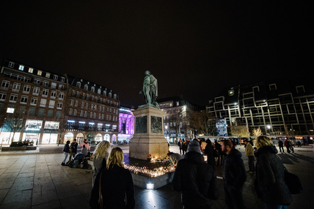 STRASBOURG, FRANCE - 14 NOV 2015: People attend a vigil and light candles in the center of Strasbourg under Gerneral Kleber statue for the victims of the November 13 attacks in Paris that killed at least 128 peopleのeditorial素材