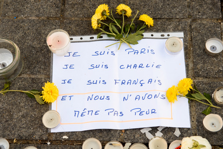 STRASBOURG, FRANCE - NOV 16, 2015: chrysanthemum, messages, candles and flowers are left around General Kleber statue in memorial for the victims of the Paris Attacks.のeditorial素材