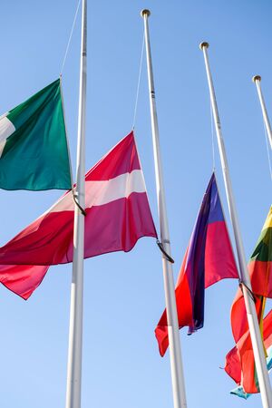 STRASBOURG, FRANCE - NOV 16, 2015: Half-mast flags in tribute to the victims of the attacks in Paris which left at least 129 people dead in front of Council of Europe buildingのeditorial素材