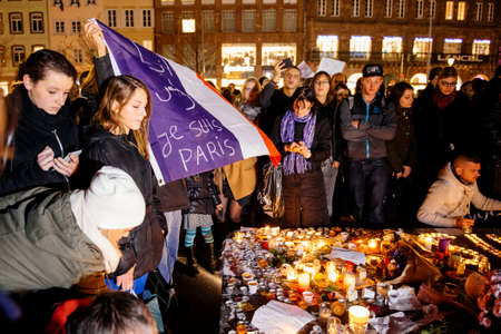 STRASBOURG, FRANCE - NOV 18, 2015: People gathering with French flag, placing flowers, messages and candles in center of Strasbourg, in solidarity for victims and families of the assault in Parisのeditorial素材