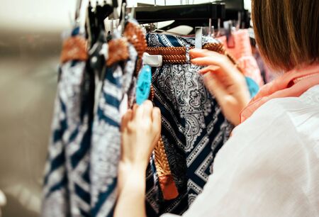 PARIS, FRANCE - JUNE 1, 2012: Tilt-shift defocused lens on a woman shopping in clotuing storeのeditorial素材