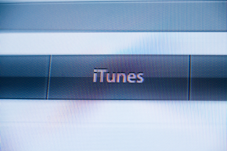 PARIS, FRANCE - SEPTEMBER 11, 2011: iTunes music store button in the non flat design of Apple Computers webiste featuring Apple computers iconic logoのeditorial素材