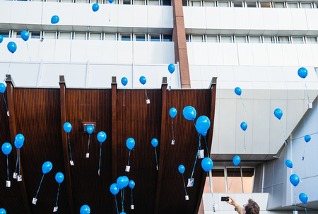 STRASBOURG, FRANCE - DEC 09, 2015: Man photographing on smartphone balloon launch for the first  European Day on the Protection of Children against Sexual Exploitation and Sexual Abuseのeditorial素材