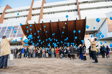 STRASBOURG, FRANCE - DEC 09, 2015: COE employees and kids celebrating the first European Day on the Protection of Children against Sexual Exploitation and Sexual Abuse by launching blue balloonsのeditorial素材
