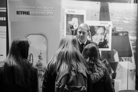 STRASBOURG, FRANCE - FEB 4, 2016: Children and teens of all ages attending annual Education Fair to choose career path and receive vocational counseling - French Marine recruitingのeditorial素材