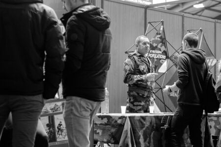 STRASBOURG, FRANCE - FEB 4, 2016: Children and teens of all ages attending annual Education Fair to choose career path and receive vocational counseling - French Army standのeditorial素材