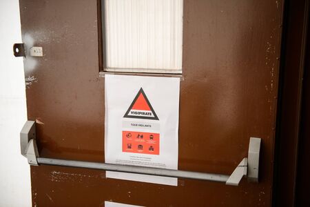 STRASBOURG, FRANCE - FEB 4, 2016: Children and teens of all ages attending annual Education Fair to choose career path and receive vocational counseling - Vigipirate sign on doorのeditorial素材