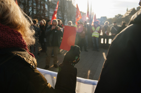 STRASBOURG, FRANCE - FEB 6, 2016: Protesters showing red carton for the government during a demonstration against government's plan to extent the 'state of emergency' and for opened borders -のeditorial素材