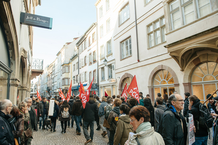 STRASBOURG, FRANCE - FEB 6, 2016: Protesters marching during a demonstration against government's plan to extent the 'state of emergency' and for opened borders on busy shopping streetのeditorial素材